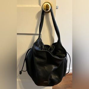 Furla large black pebbled leather drawstring bag. Twisted shoulder strap.